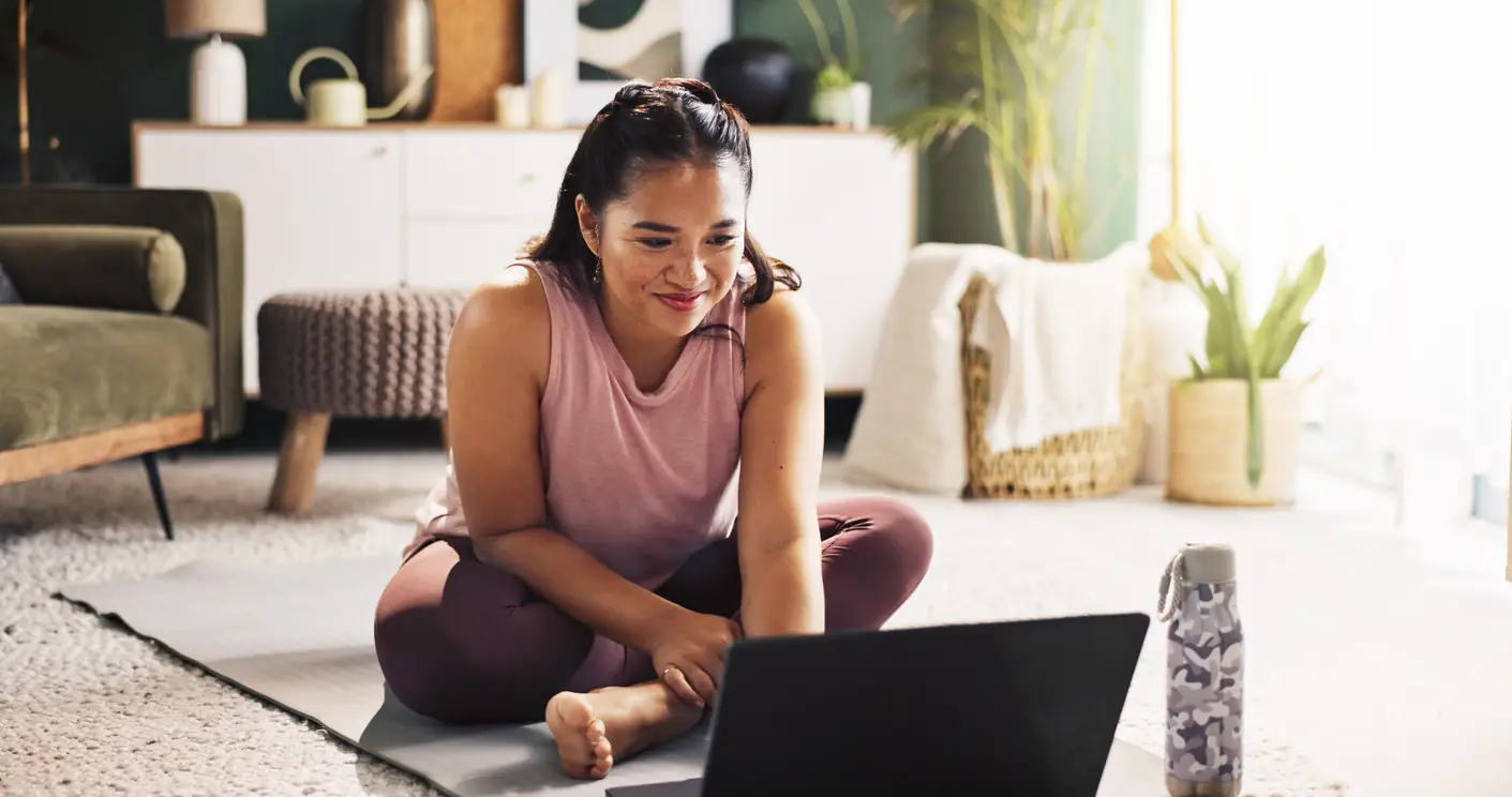 Woman on a yoga mat joining a virtual nutrition session