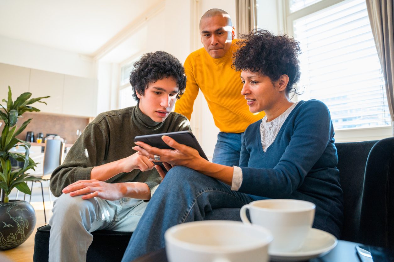 A family going through nutrition guidance together on a tablet